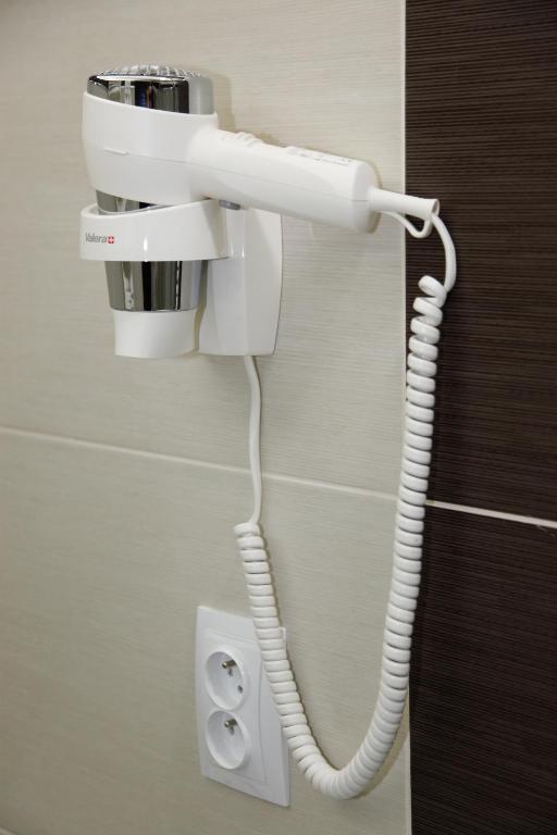 a telephone hanging from a wall in a bathroom at Pension Dvořák in Karlovy Vary