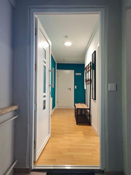 a hallway with a door open to a room with a table at Ferienwohnung Freedom 2 Sky Terrasse High End in Northeim