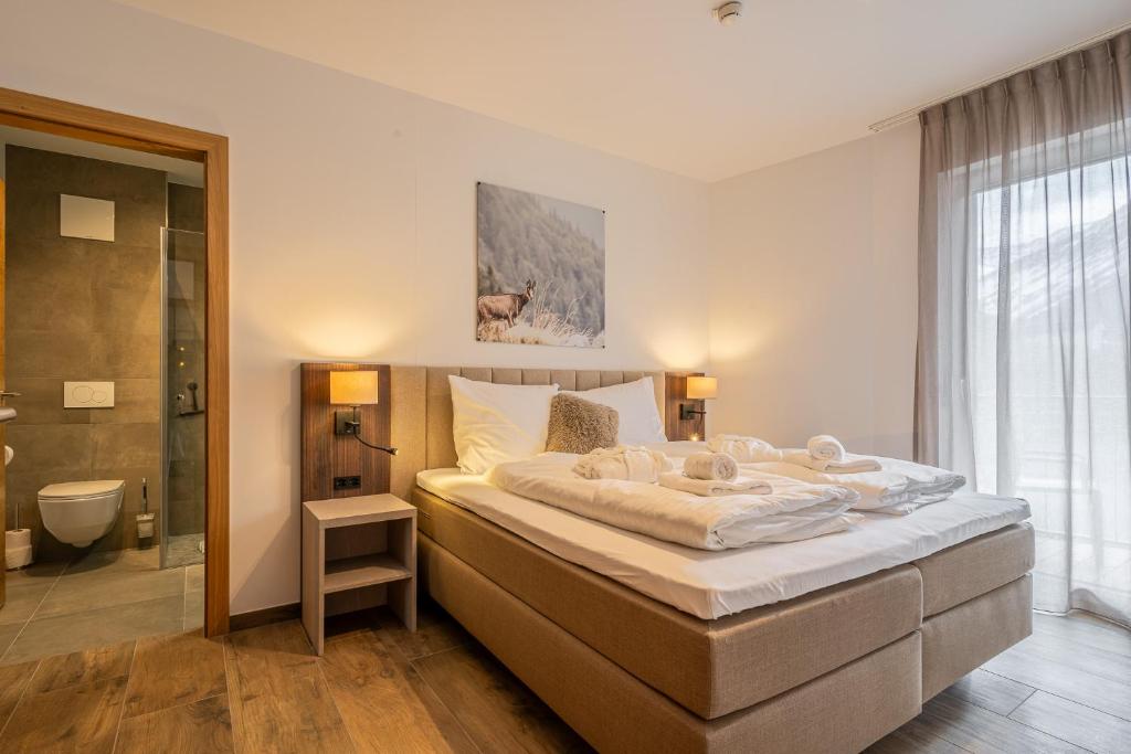 Postel nebo postele na pokoji v ubytování Alpenzauber Apartments by Monteviva