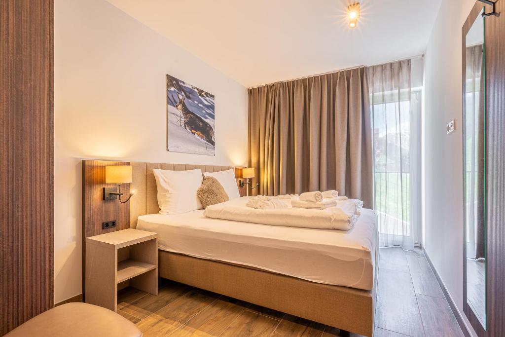 Postel nebo postele na pokoji v ubytování Alpenzauber Apartments by Monteviva