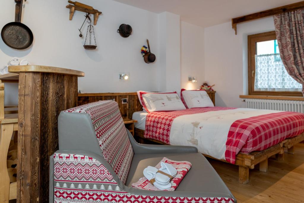 Postel nebo postele na pokoji v ubytování Garnì Ladin