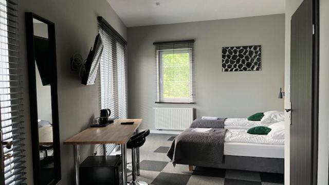 プワヴィにあるApartamenty Marciniakのベッドと机が置かれた寝室