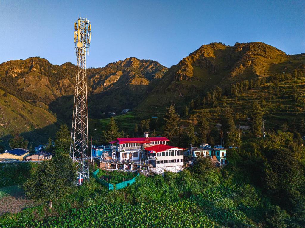 an aerial view of a house with a tower at Gulab - B Homestay in Dehradun