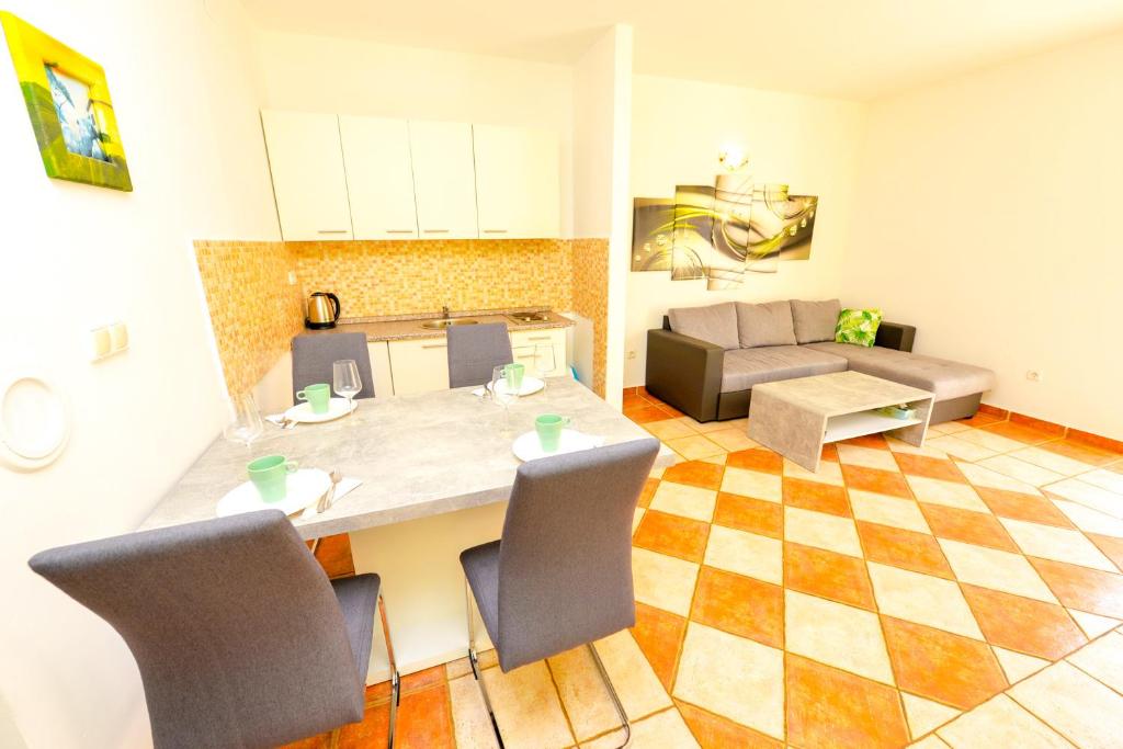 kuchnia i salon ze stołem i krzesłami w obiekcie Apartment Dadi w Novalji