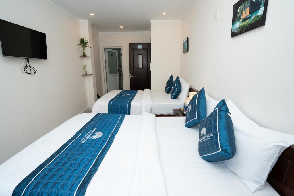 Postel nebo postele na pokoji v ubytování Mountain Pearl Hotel