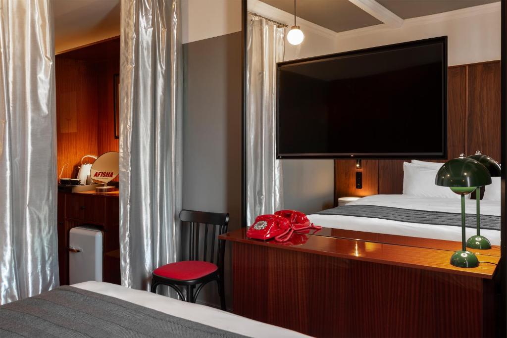 Postel nebo postele na pokoji v ubytování Hotel Afisha