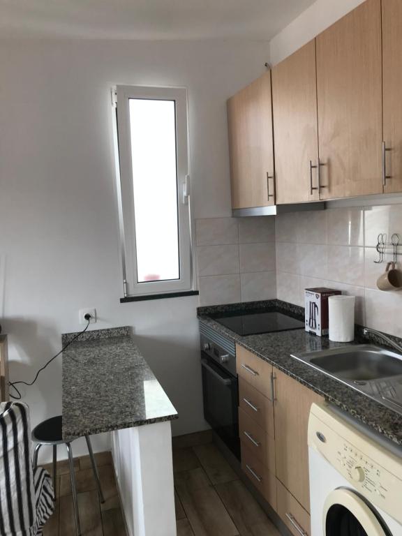 a kitchen with a sink and a counter top at Casa Beleza in Funchal
