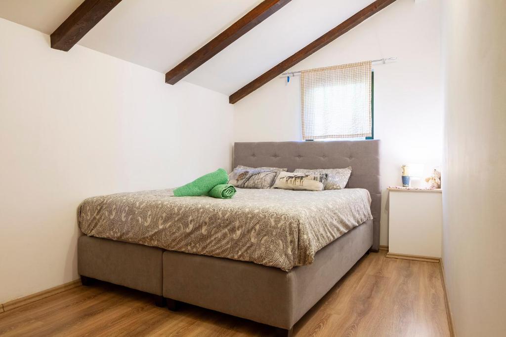a bedroom with a bed in a attic at Woodland Retreat in Donji Zagon