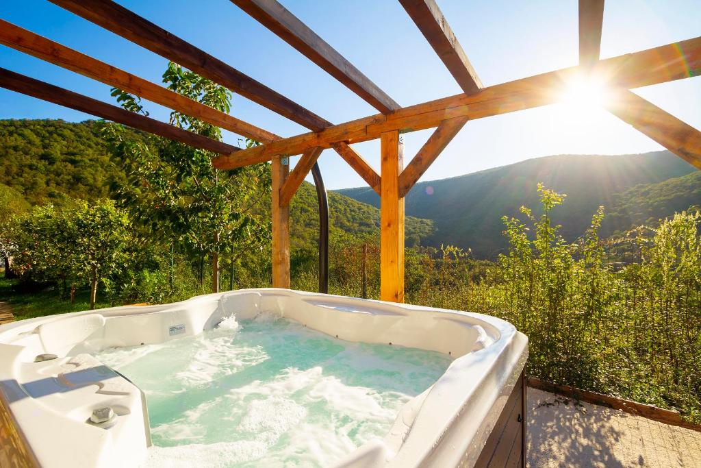 a bath tub with a view of the mountains at Woodland Retreat in Donji Zagon