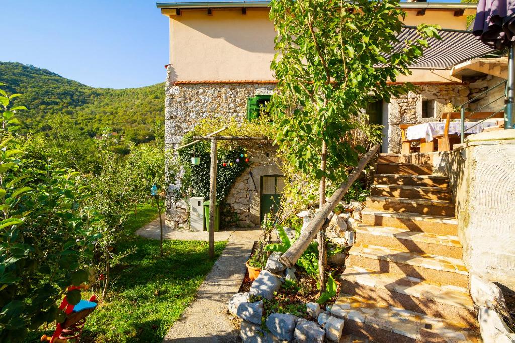 a house with a garden in front of it at Woodland Retreat in Donji Zagon