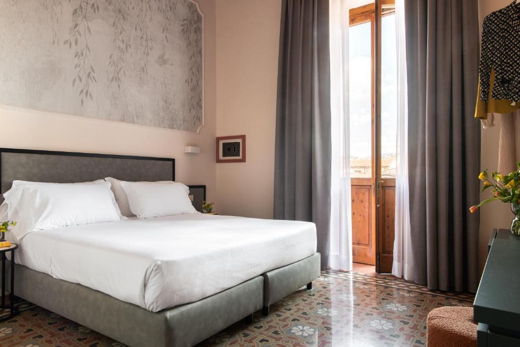 Postel nebo postele na pokoji v ubytování Hotel Fiorita