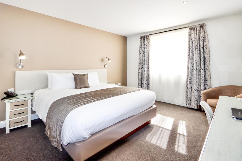 Ένα ή περισσότερα κρεβάτια σε δωμάτιο στο All Saints Resort