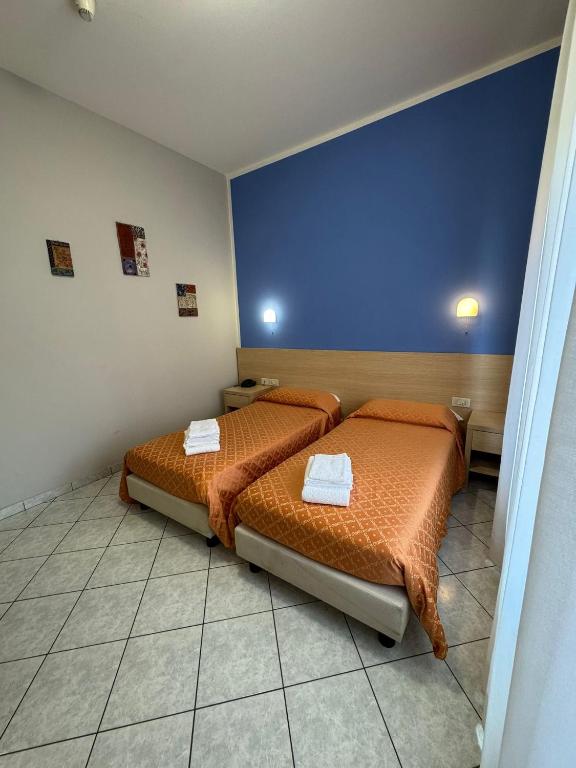 Postel nebo postele na pokoji v ubytování Albergo La Posta Arezzo