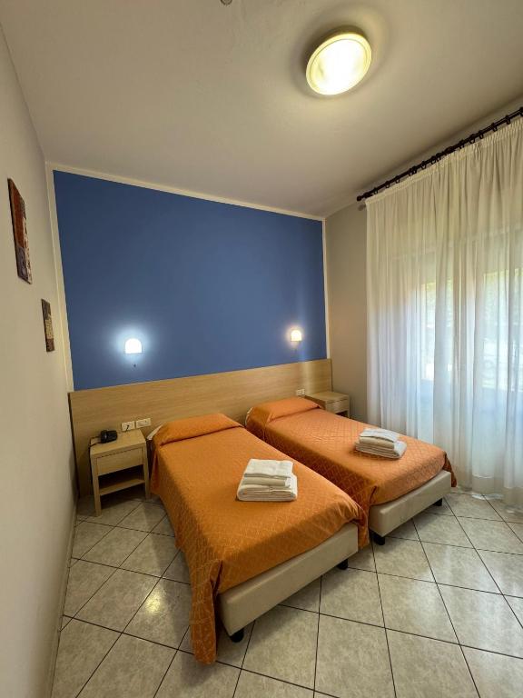 Postel nebo postele na pokoji v ubytování Albergo La Posta Arezzo