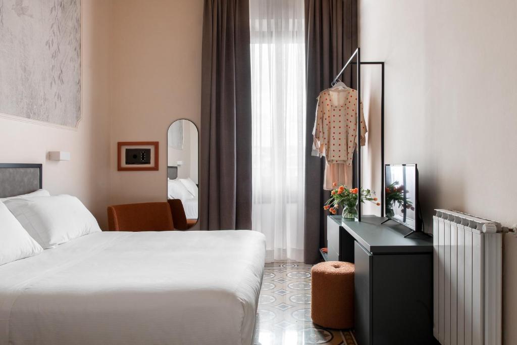 Postel nebo postele na pokoji v ubytování Hotel Fiorita