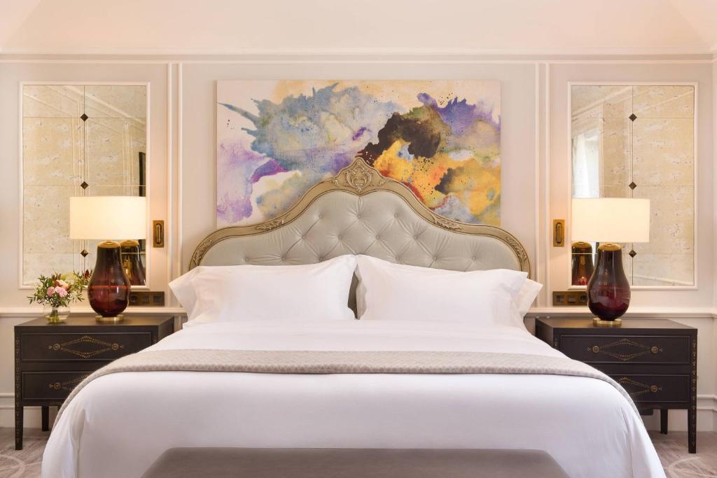a bedroom with a large white bed with two night stands at Hotel Maria Cristina, a Luxury Collection Hotel, San Sebastian in Donostia-San Sebastián