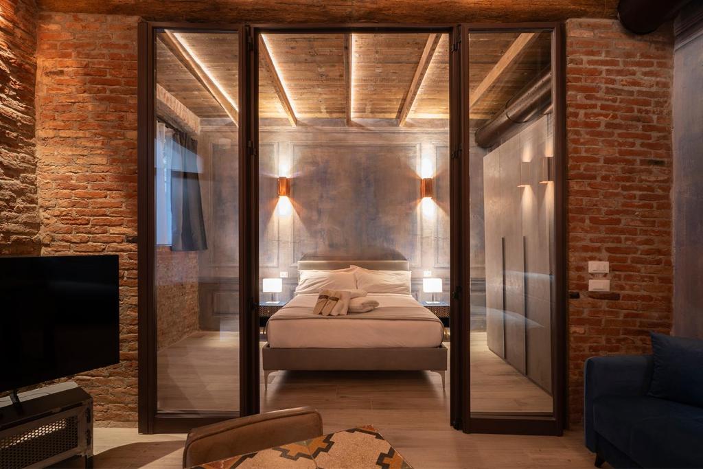 a bedroom with a bed with a glass wall at Emme Loft I Blue Moon - Elegant Luxury Loft Milan in Milan