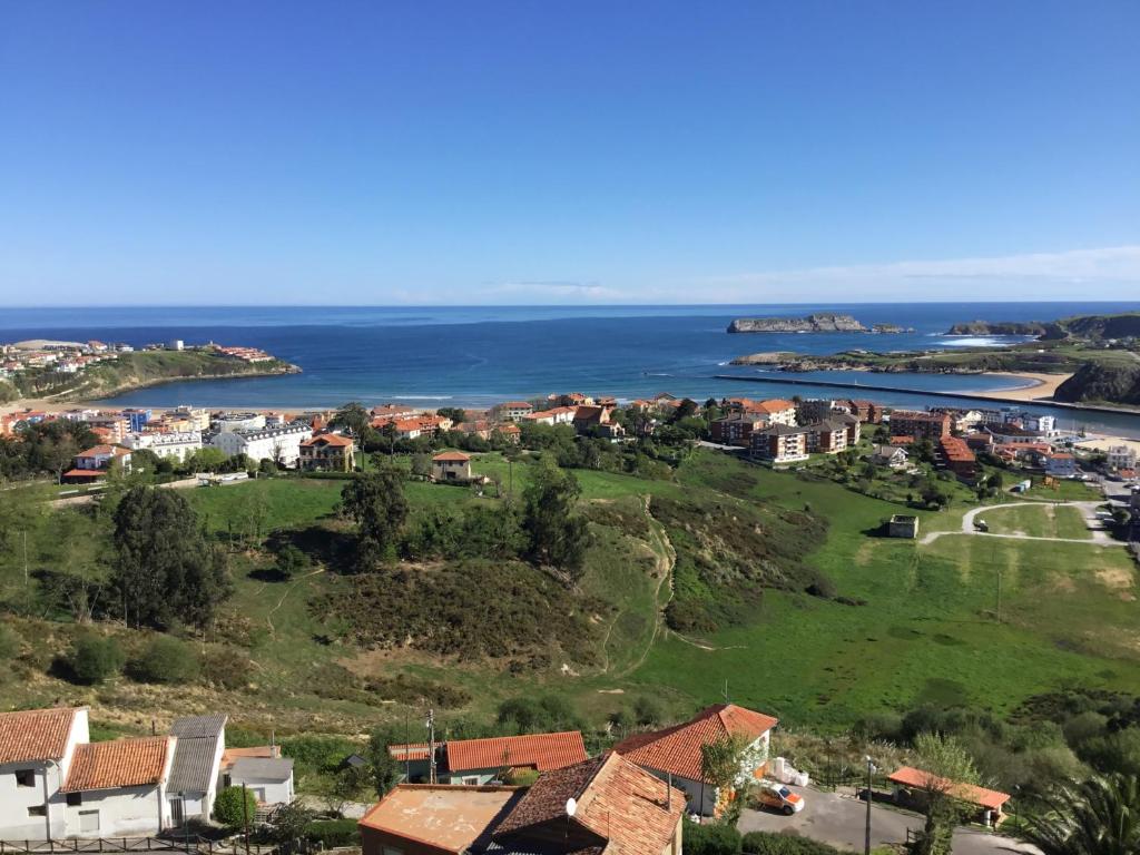 a view of a town and the ocean at El mirador in Suances