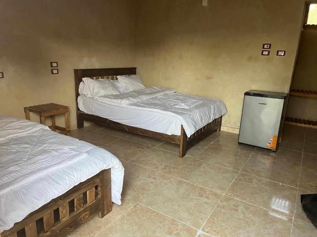 Postel nebo postele na pokoji v ubytování فندق إريغن Erighin siwa hotel
