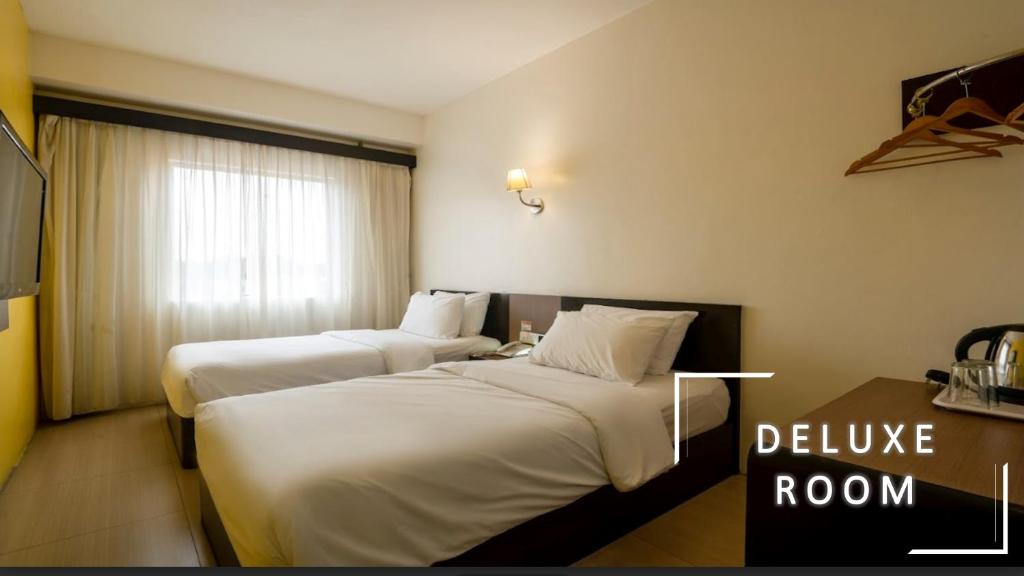 Postel nebo postele na pokoji v ubytování STREETVIEW HOTEL