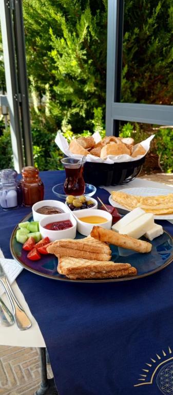 a blue table topped with a plate of bread and dips at Port Hotel, Tasucu in Silifke
