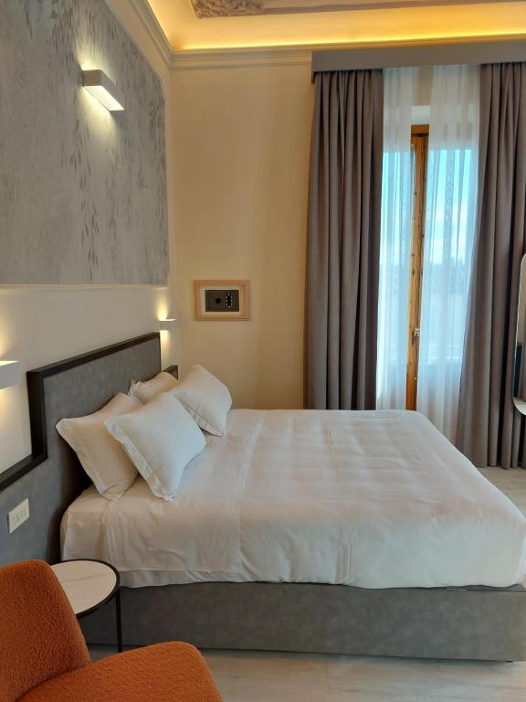 Postel nebo postele na pokoji v ubytování Hotel Fiorita
