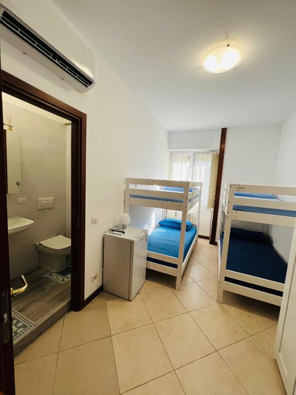 Postel nebo postele na pokoji v ubytování Gigli, rooms con cucina in comune e terrazza