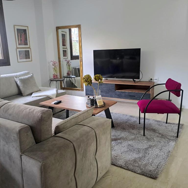 a living room with a couch and a table at La Maisonette, Florina Center in Florina
