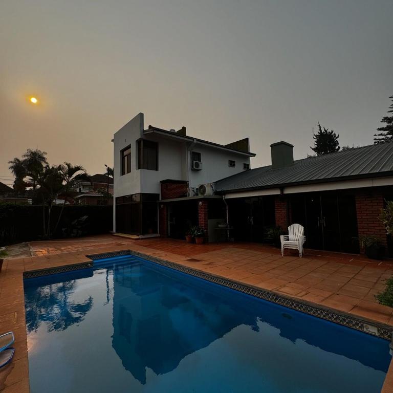 a swimming pool in front of a house at LA CASONA jn in Posadas