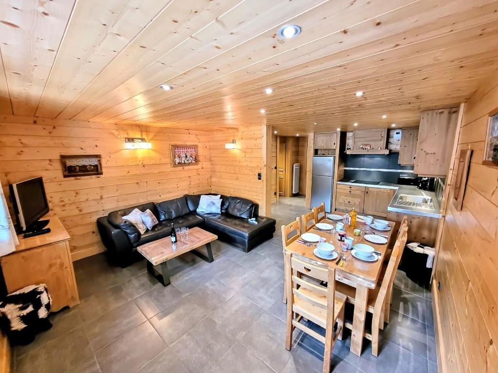 a large living room with a couch and a table at Superbe T3 + cabine au centre des Gets, proche pistes, 7 pers, 4⭐, Wifi, équipements complets - FR-1-598-83 in Les Gets