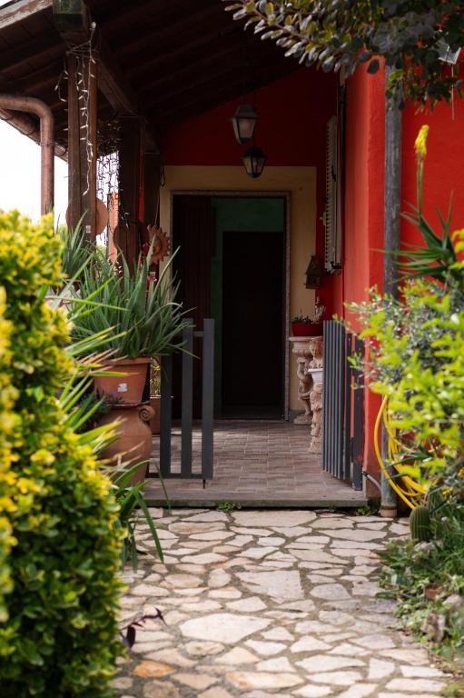 an entrance to a red building with a door at Casa Ragno Corchiano in Corchiano