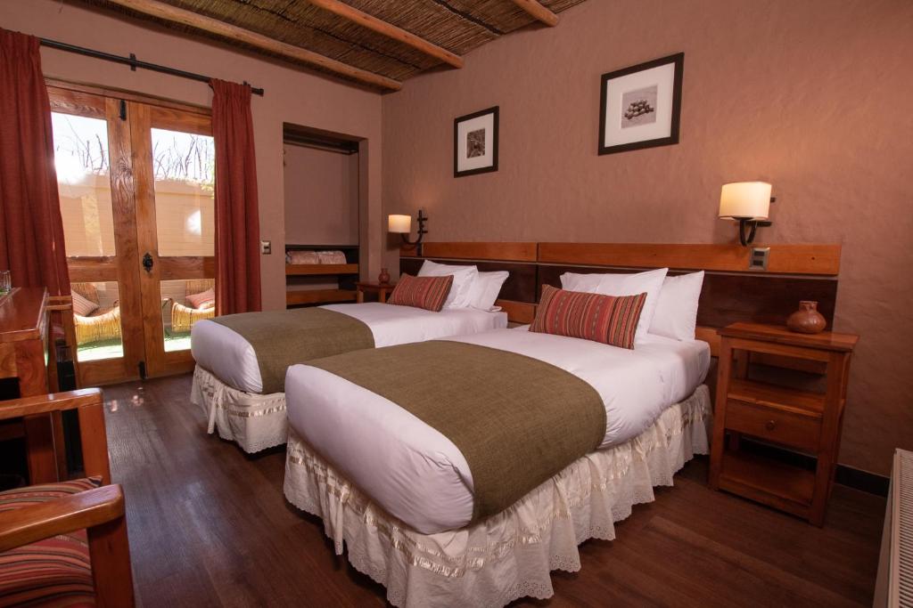 Postel nebo postele na pokoji v ubytování Hotel Pascual Andino