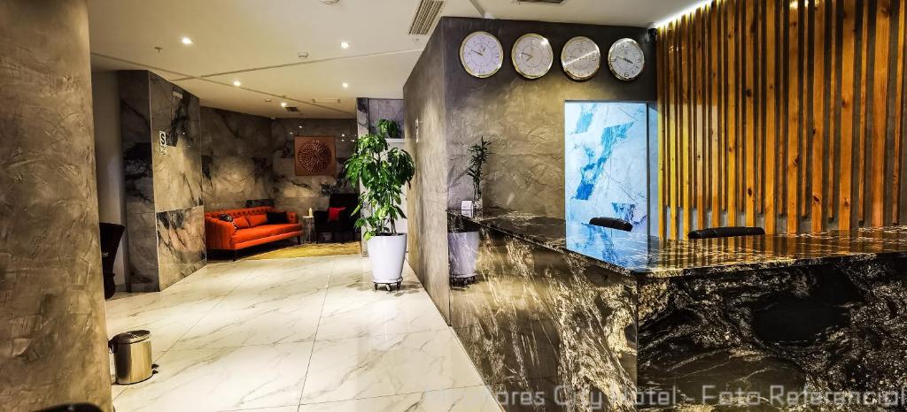 a lobby with a marble counter and an orange couch at MIRAFLORES CITY HOTEL in Lima