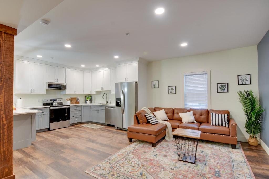 a living room with a couch and a kitchen at Walk to Lititz Springs Park Cozy Getaway! in Lititz