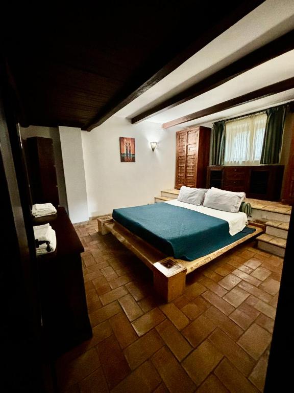 a bedroom with a large bed in a room at Locanda delle sorelle in Campagnano di Roma