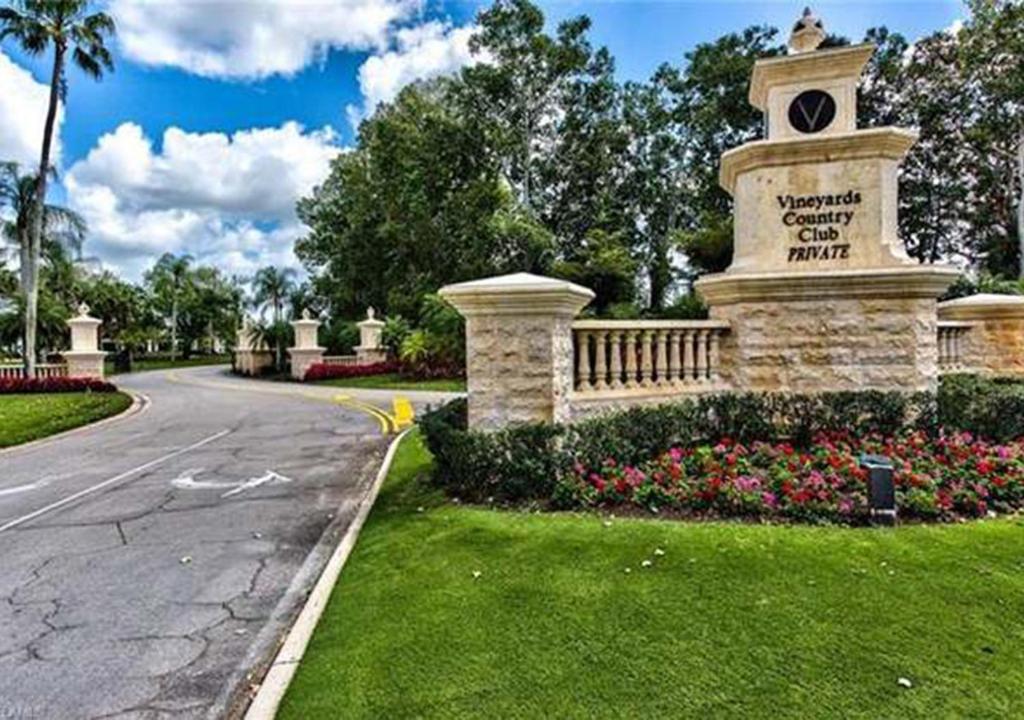 a stone monument with a clock tower in a park at Paradise Gem in Naples