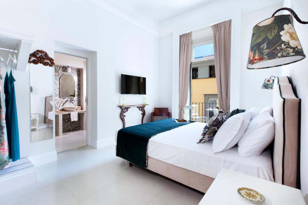 Postel nebo postele na pokoji v ubytování Grace Suites Sorrento
