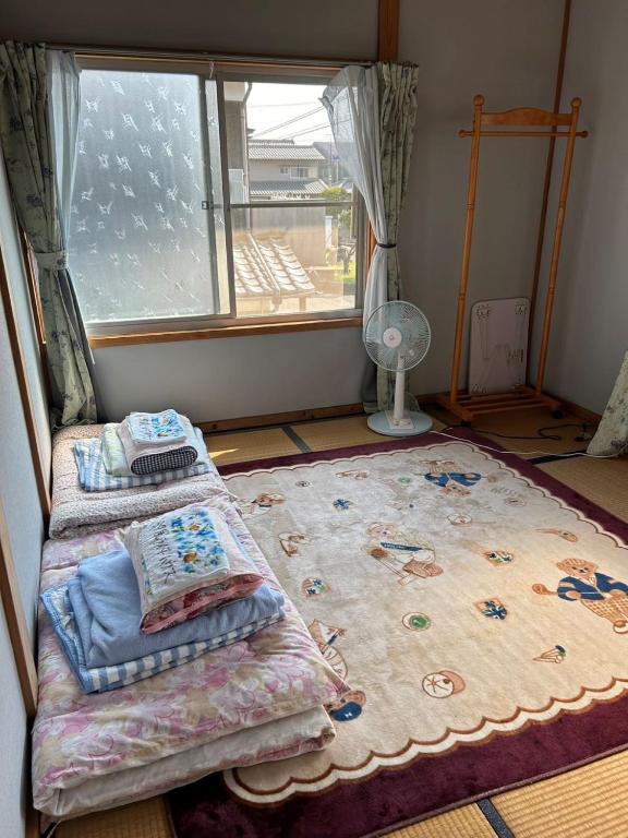 Postel nebo postele na pokoji v ubytování 汐風ライダーハウス -Shiokaze rider house-
