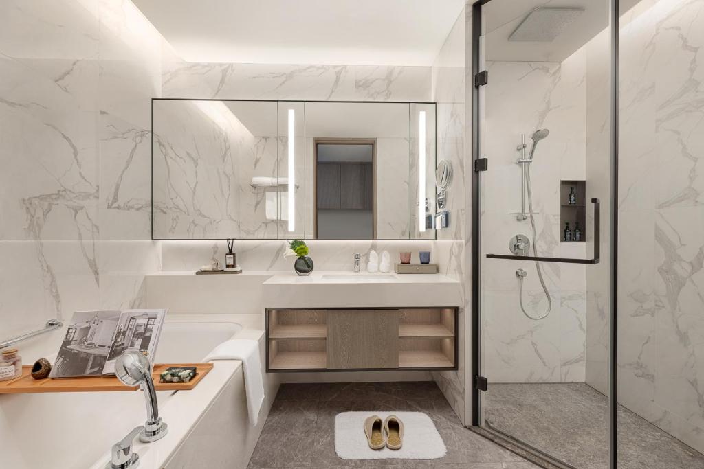 a bathroom with a sink and a shower at Somerset QPlex Shenzhen in Shenzhen