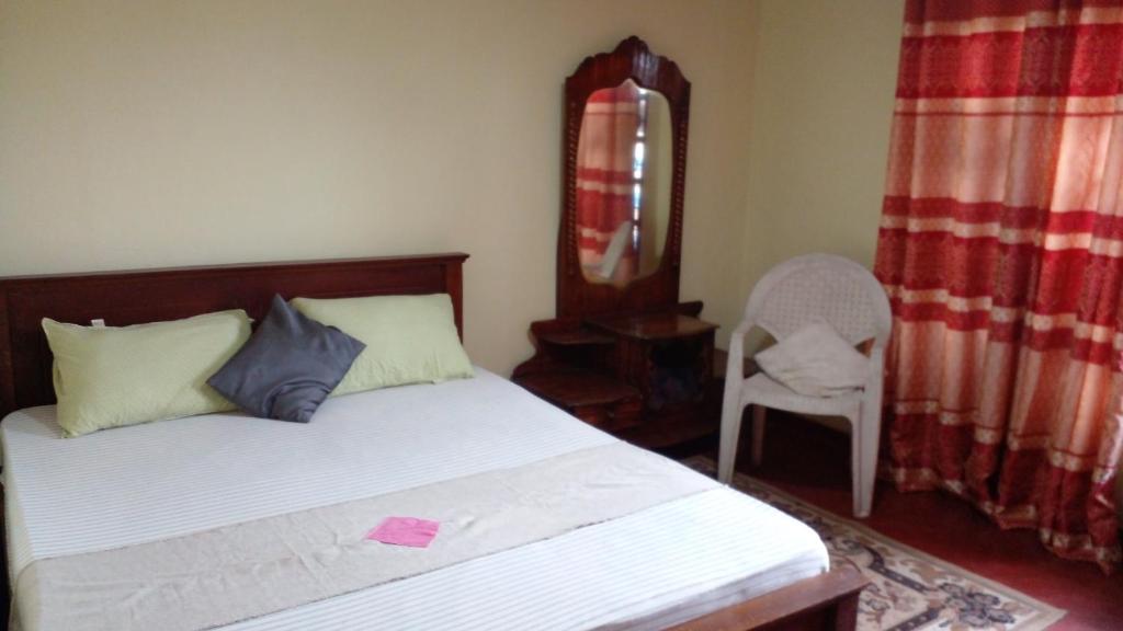 Postel nebo postele na pokoji v ubytování Haranya Homestay
