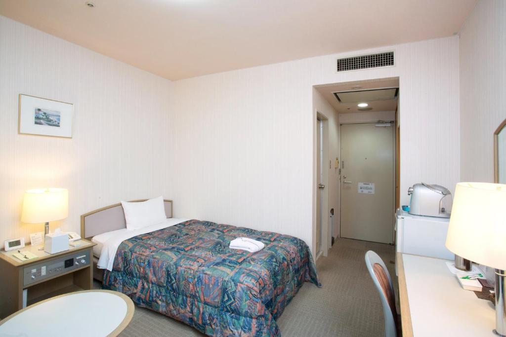 Postel nebo postele na pokoji v ubytování Hotel Rubura Ohzan