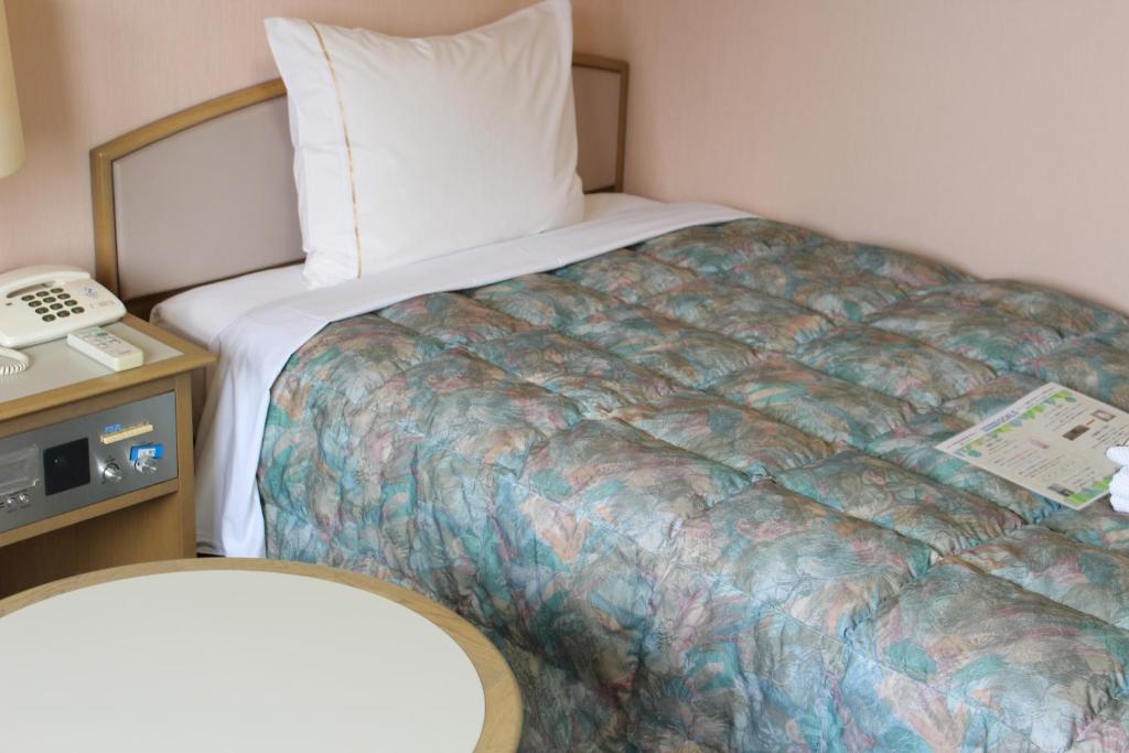 Postel nebo postele na pokoji v ubytování Hotel Rubura Ohzan