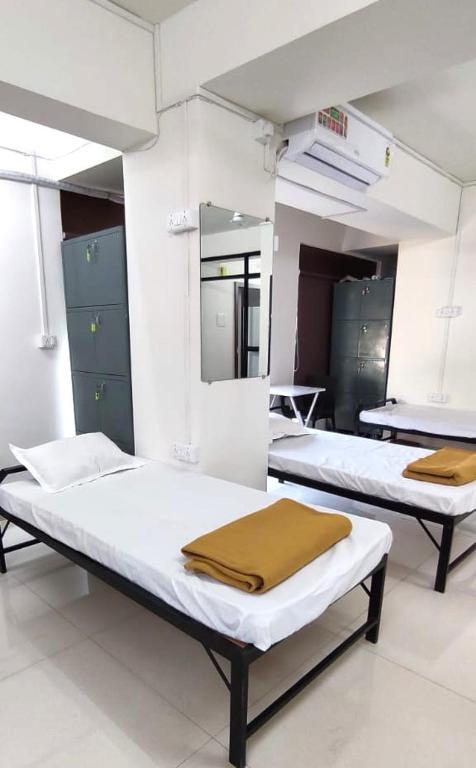 Postel nebo postele na pokoji v ubytování Trident Hospitalities