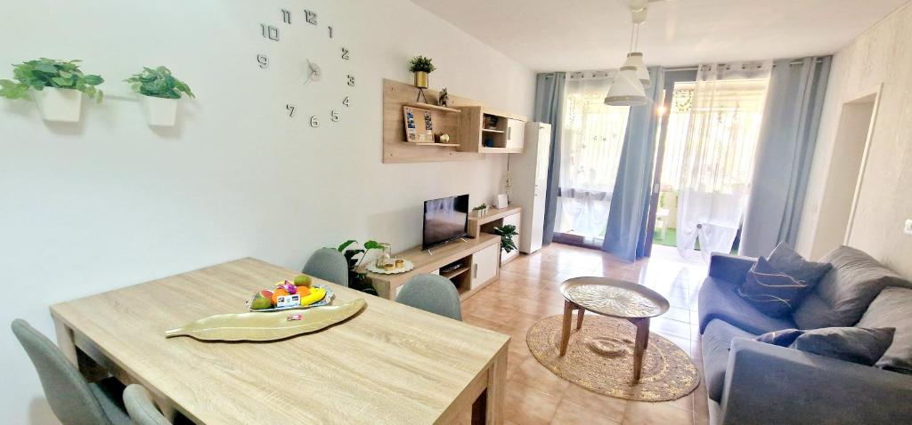 a living room with a table and a dining room at Casa GABRIEL 1 Bedroom Wifi Free Pool in Costa Del Silencio