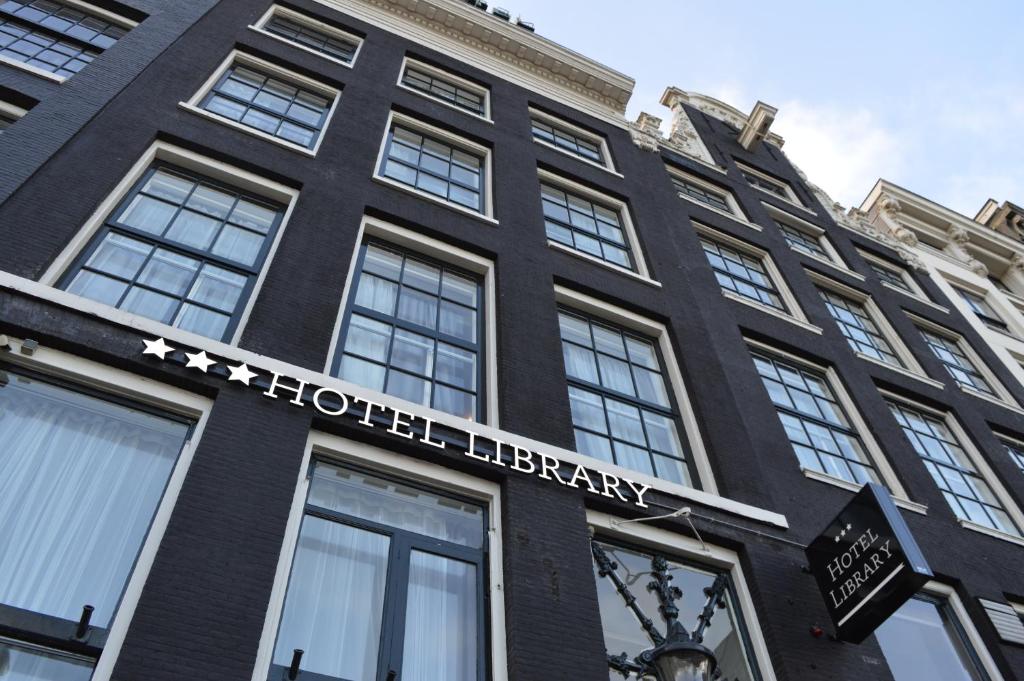 a black building with the words harrods library on it at Hotel Library Amsterdam in Amsterdam