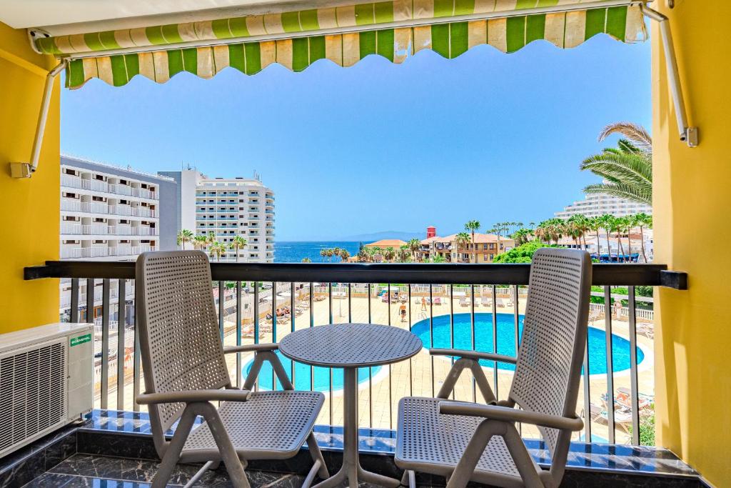 a balcony with a table and chairs and the ocean at Luxury Copacabana in Costa de Adeje