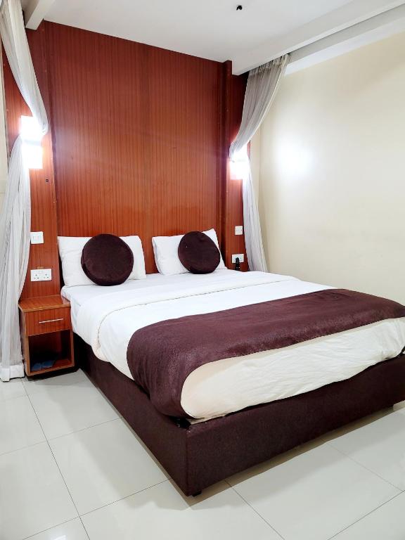 Postel nebo postele na pokoji v ubytování Nairobi Glory Palace Hotel
