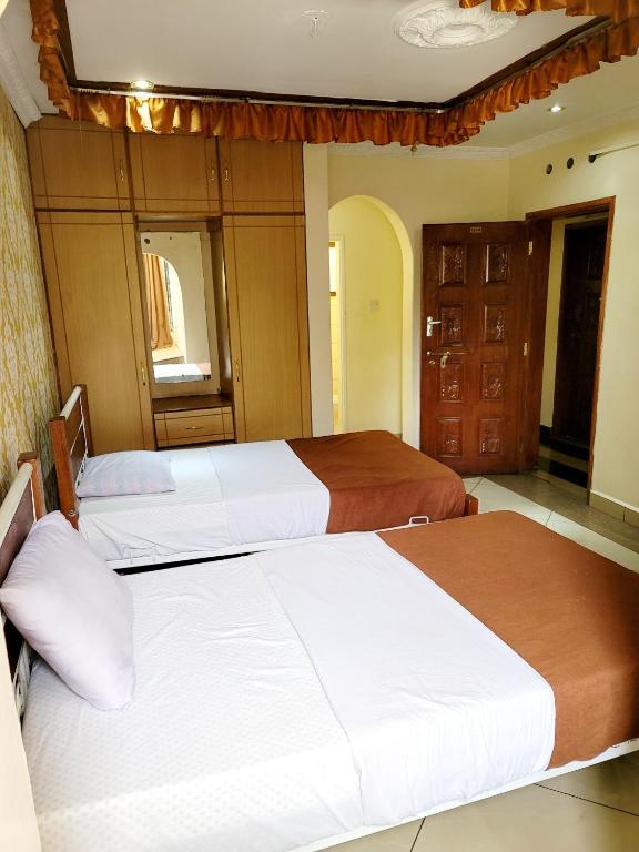 Postel nebo postele na pokoji v ubytování Nairobi Glory Palace Hotel
