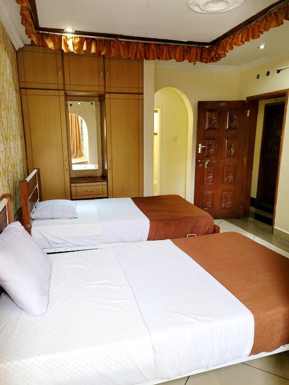 Postel nebo postele na pokoji v ubytování Nairobi Glory Palace Hotel