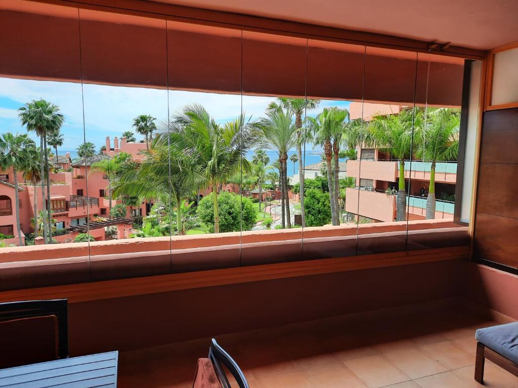 an office window with a view of palm trees at Las Salinas in Estepona